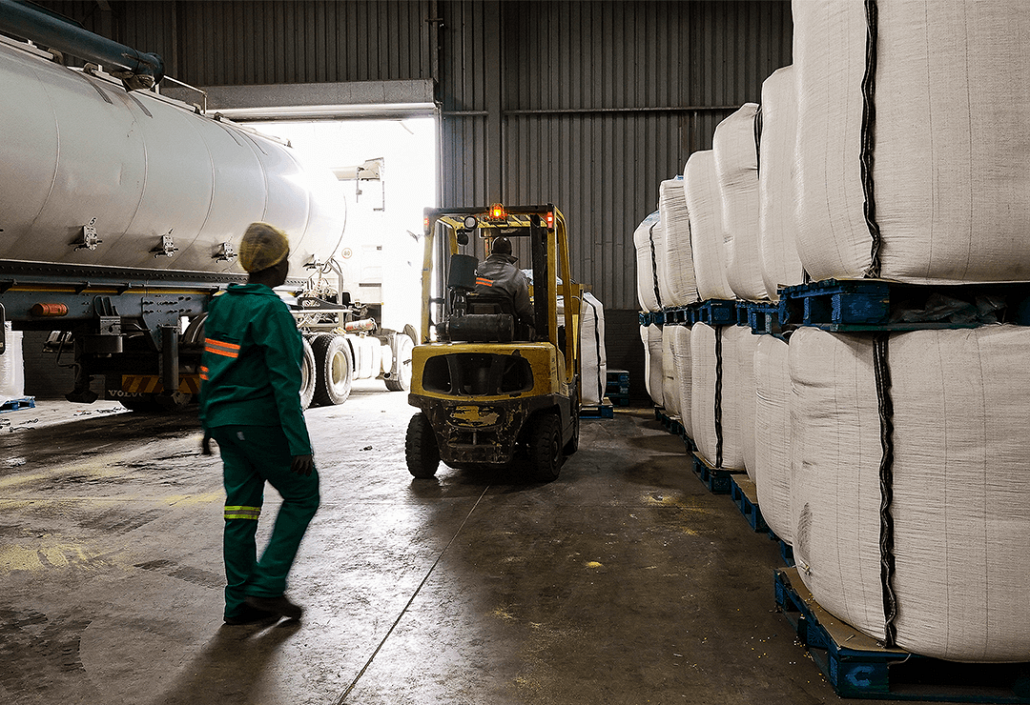 Worker and forklift in warehouse