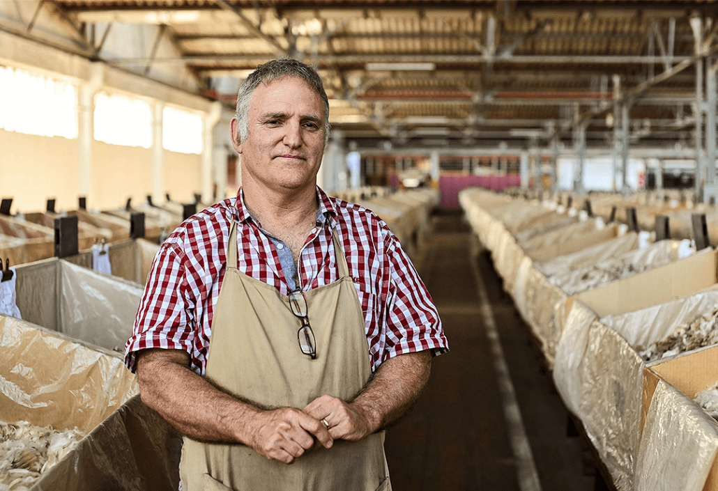 man in apron in wool store