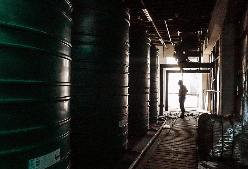 Man standing with water tanks